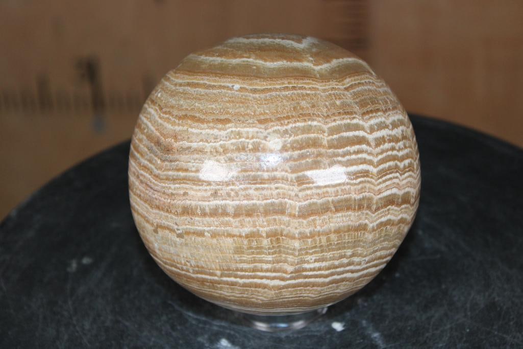 XL Polished BANDED ARAGONITE Mineral Sphere: XL Polished BANDED ARAGONITE Mineral Sphere. It measures 4.75" in Diameter and Weighs 5.05 lbs. Banded Aragonite is a calcium carbonate mineral known for its earthy, layered bands and grounding proper