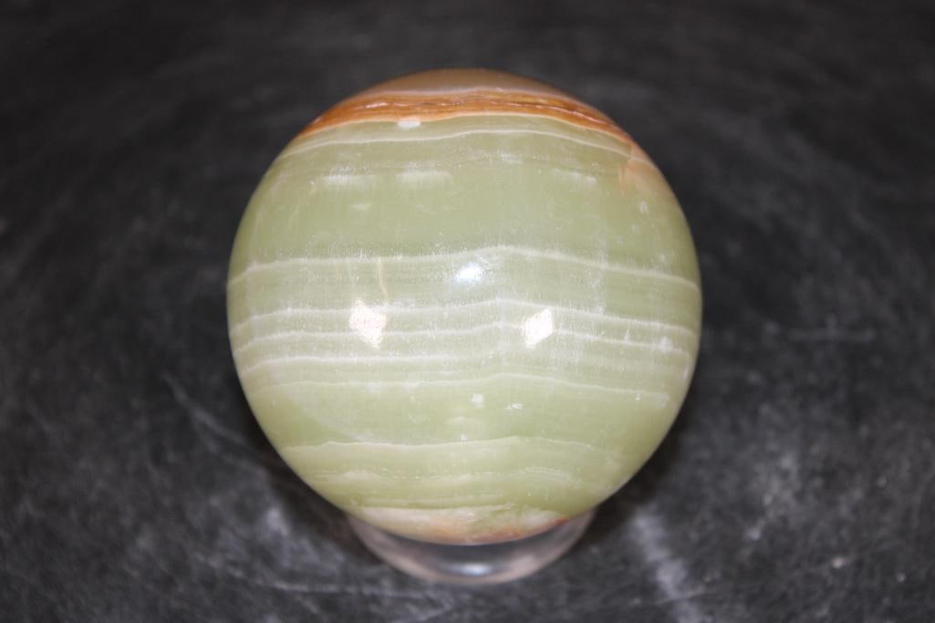 Polished GREEN BANDED ONYX Mineral Sphere: Polished GREEN BANDED ONYX Mineral Sphere. It measures 3" in Diameter and Weighs 1.3 lbs. It comes with a plastic ring stand for display. ROCKS FOSSILS MINERALS 