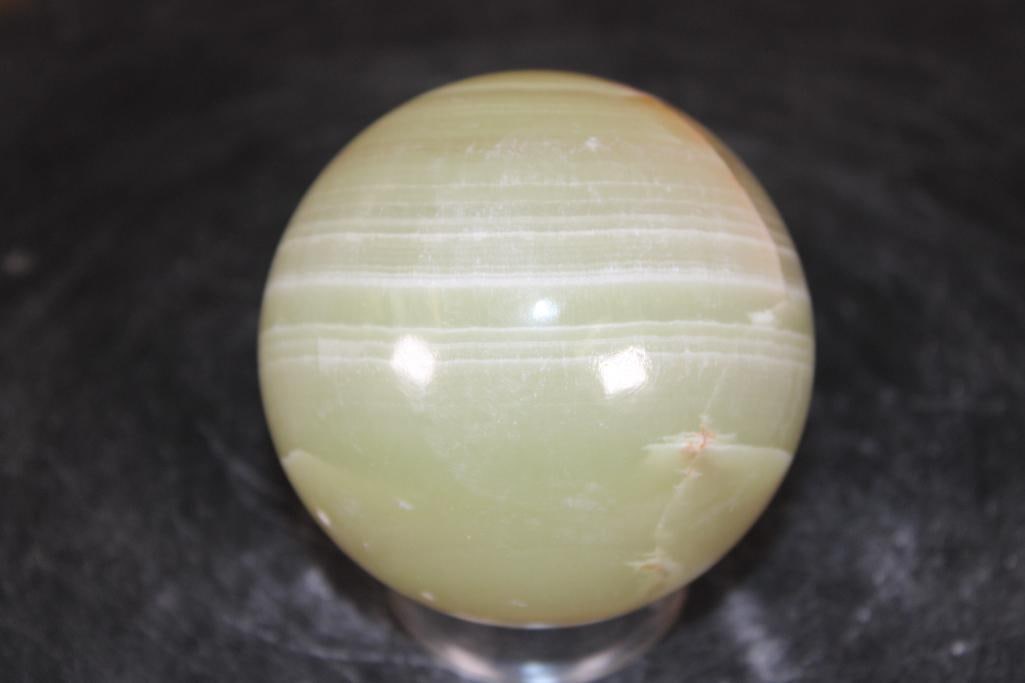 Polished GREEN ONYX Mineral Sphere: Polished GREEN ONYX Mineral Sphere. It measures 3" in Diameter and Weighs 1.3 lbs. It comes with a plastic ring stand for display. ROCKS FOSSILS MINERALS