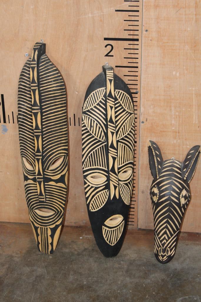 Matching Set of (3) Hand-carved African Tribal MASKS: Set of 3 matching hand-carved African Tribal MASKS. There are 2 Larger Masks that measure approximately 22.5"- 24.5" Tall. The Zebra Mask measures 14" Tall. AFRICAN ART AND ARTIFACTS 