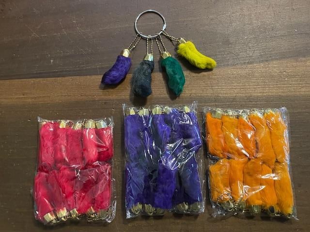 (30) "Good Luck" or "Lucky" RABBITS FEET Keychains or Purse Charms: 30 "Good Luck" or "Lucky" Taxidermy RABBITS FEET Keychains or Purse Charms. They have Brass Caps and measure 2.5"-3" Long each. There is vibrant pink, purple, and orange. *The singles on the keychain