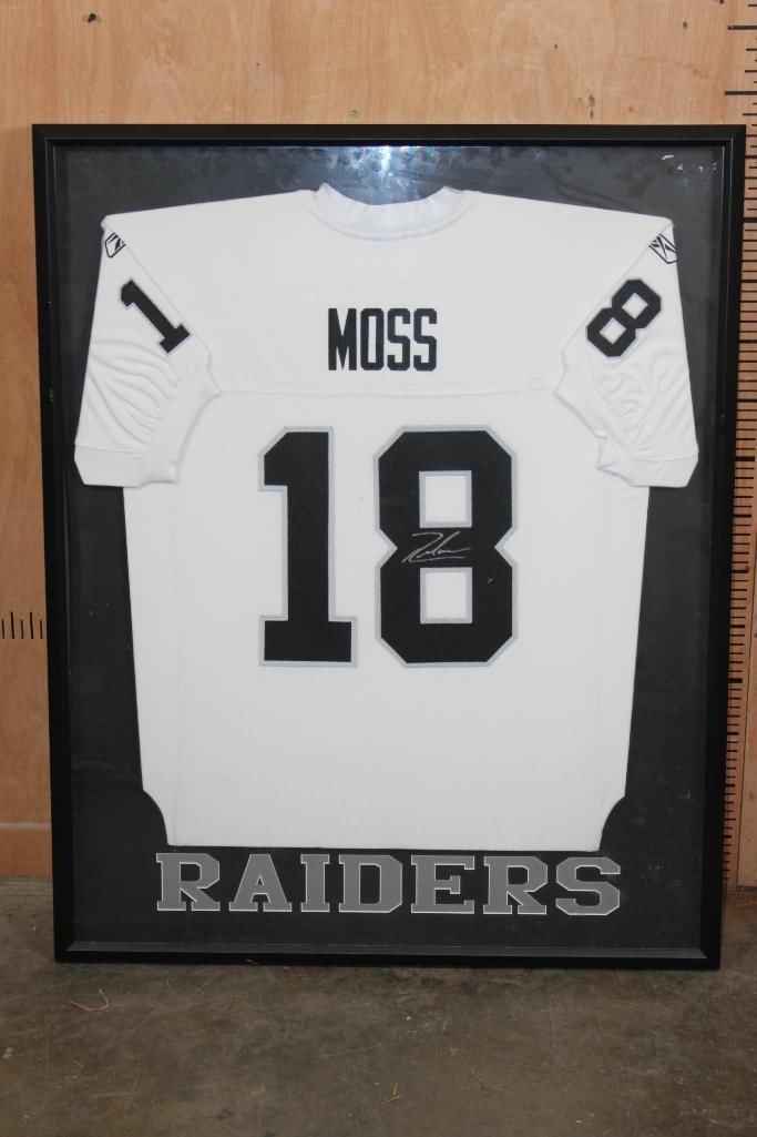 Autographed Randy Moss Oakland Raiders Jersey in a Shadowbox Frame: Vintage Reebok Oakland Raiders Jersey #18 Signed by Randy Moss. It is displayed in a Shadowbox Frame made from wood and glass. It measures 42" Tall x 33.5" Wide. COLLECTIBLE SPORTS APPAREL JERSEYS