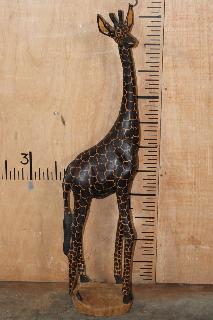 Hand-carved Wood GIRAFFE Sculpture: Wood GIRAFFE Sculpture Hand-carved from a single piece of wood. It measures 9" Long x 8" Wide x 35" Tall and Weighs 9 lbs 1 oz. The rear left ankle is broken. These sculptures are made by artisans in