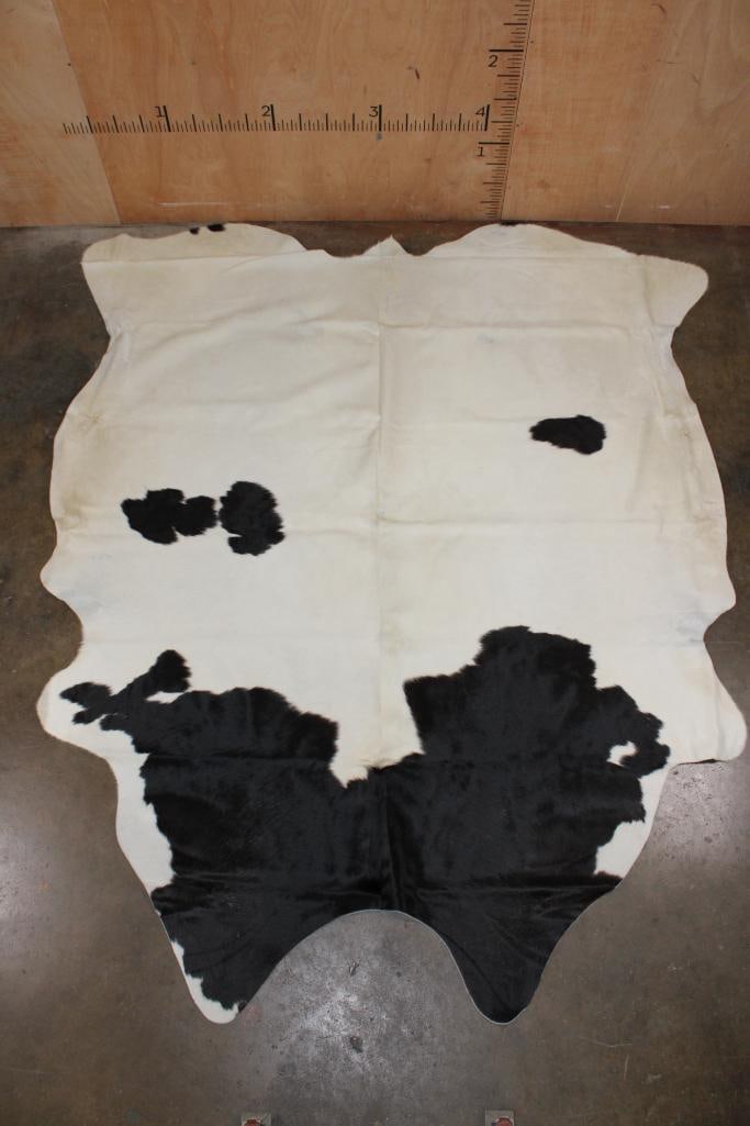 *Brand New* Black and White COWHIDE or COWHIDE Rug: *Brand New* Black and White COWHIDE or COWHIDE Rug that looks like a dairy cow! It measures 91" Long x 78" Wide and is made from 100% genuine Cowhide Leather. Cowhides are known for being