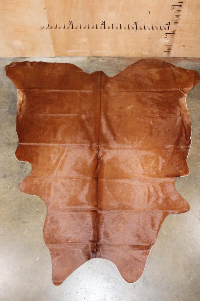 *Brand New* Brown COWHIDE or COWHIDE Rug: *Brand New* Brown COWHIDE or COWHIDE Rug. It measures 85" Long x 80" Wide and is made from 100% genuine Cowhide Leather. Cowhides are known for being durable, easy to clean, and hypoallergenic. They