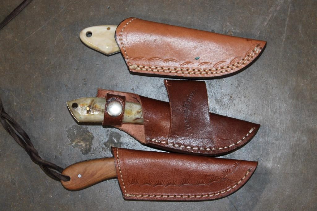 (3) Fixed Blade Damascus Steel KNIVES with Bone, Horn, and Wood Handles and Leather Sheaths: 3 Fixed Blade Damascus Steel KNIVES. 1 made in the U.S.A. "Texan Knives" 6.75" Long Knife with an Antler Handle and a matching Leather Sheath. 1 Damascus Steel Knife that measures 6.75" Long, has a