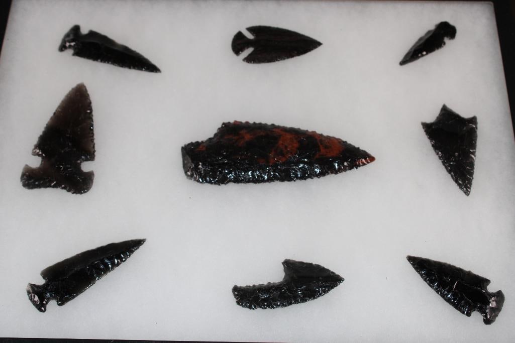 (9) Native American Mahogany Obsidian ARROWHEADS or Projectile Points in a Display Case: 9 Native American Mahogany Obsidian ARROWHEADS or Projectile Points. They measure 2" to 5" Long each. They are displayed in a Case with Glass that measures 26.25" Long x 12.25" Wide. Mahogany