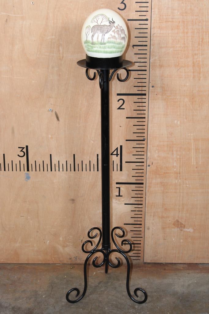 Scrimshawed OSTRICH Egg by African Artist "NQO" displayed on a Tall Metal Stand: Hand-crafted, Scrimshawed, and Hand-painted OSTRICH Egg by African artist "NQO". A lovely image of an Nyala can be seen. It is displayed on a tall Metal Stand that measures 31" Tall x 10" Long x 10" W