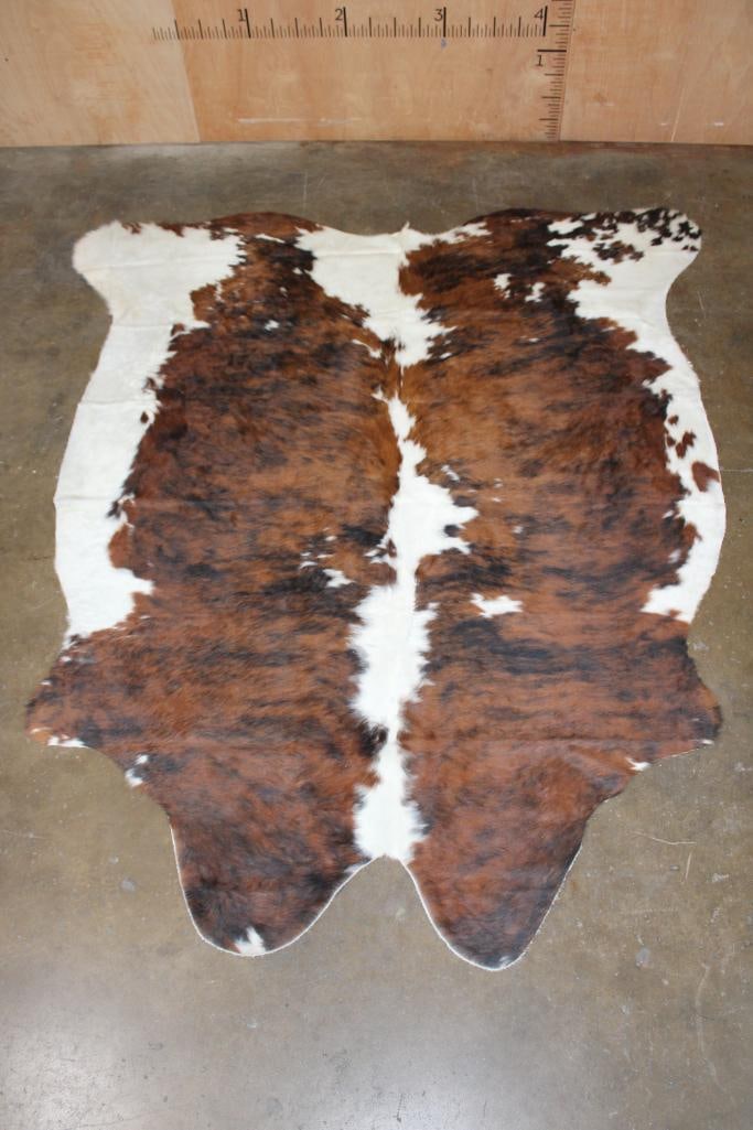 *Brand New* Brindle and White COWHIDE or COWHIDE RUG: *Brand New* Brindle and White COWHIDE or COWHIDE RUG. It measures 86" Long x 75" Wide and is made from 100% genuine Cowhide Leather. Cowhides are known for being durable, easy to clean, and