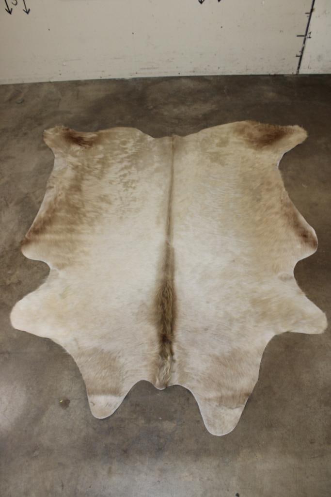 *Brand New* "Champagne" Blonde and Tan COWHIDE or COWHIDE RUG: *Brand New* "Champagne" Blonde and Tan COW HIDE. It measures 79" Long x 69" Wide and is made from 100% genuine Cowhide Leather. Cowhides are known for being durable, easy to clean, and