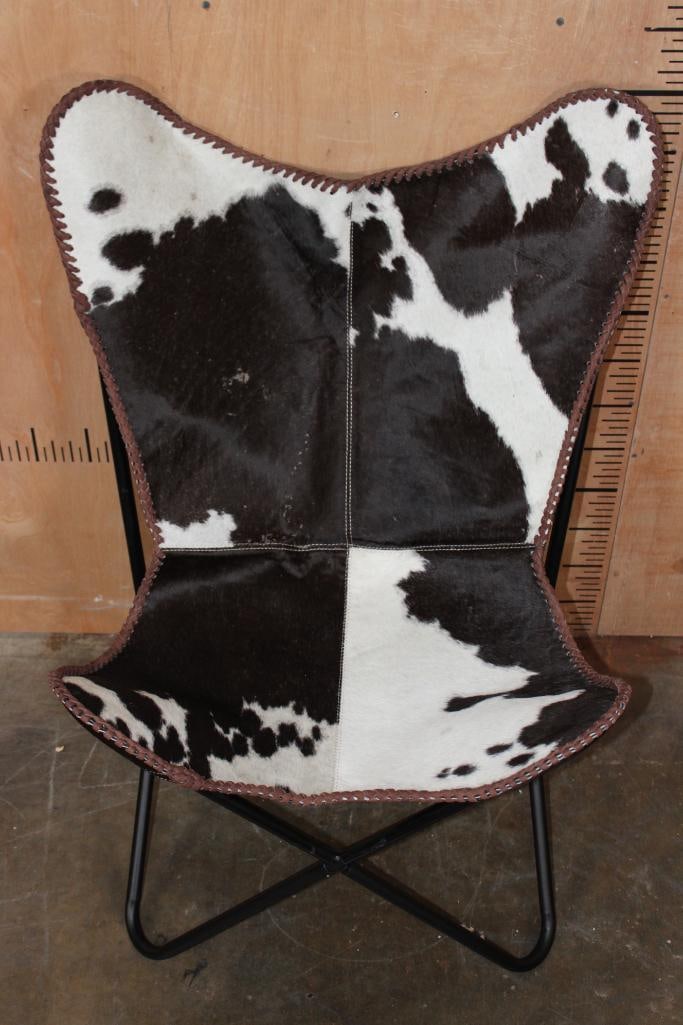 *Brand New* Black and White COWHIDE CHAIR with a Black Metal Folding Frame: *Brand New* Black and White COWHIDE Leather "Butterfly" CHAIR with a sling seat design and black metal frame. It measures 28" Long x 25" Wide x 38" Tall and is made from 100% genuine Cowhide Leather.
