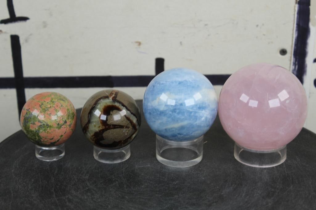 (4) Polished Mineral SPHERES with Plastic Ring Stands: 1 Rose Quartz that measures 3" Diameter and Weighs 1lb 6 oz, 1 Blue Celestite that measures 2.5" Diameter and Weighs 14.5 oz, 1 Septarian Dragon Stone that measures 2" Diameter and Weighs 8.