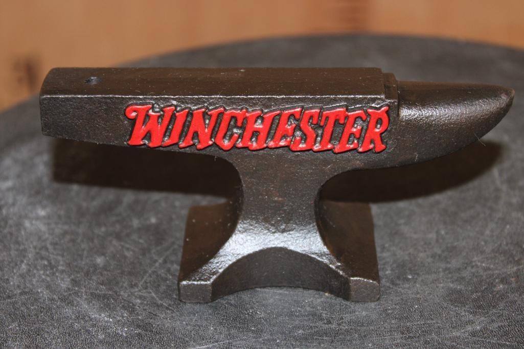 Cast Iron Reproduction "Winchester" Gunsmithing Miniature ANVIL: Reproduction "Winchester" Gunsmithing Miniature ANVIL. The Winchester Logo is painted on red. It measures 5 5/8" Long x 2" Wide x 2.5" Tall and Weighs 1 lb 12 oz. GUNSMITHING COLLECTIBLES 
