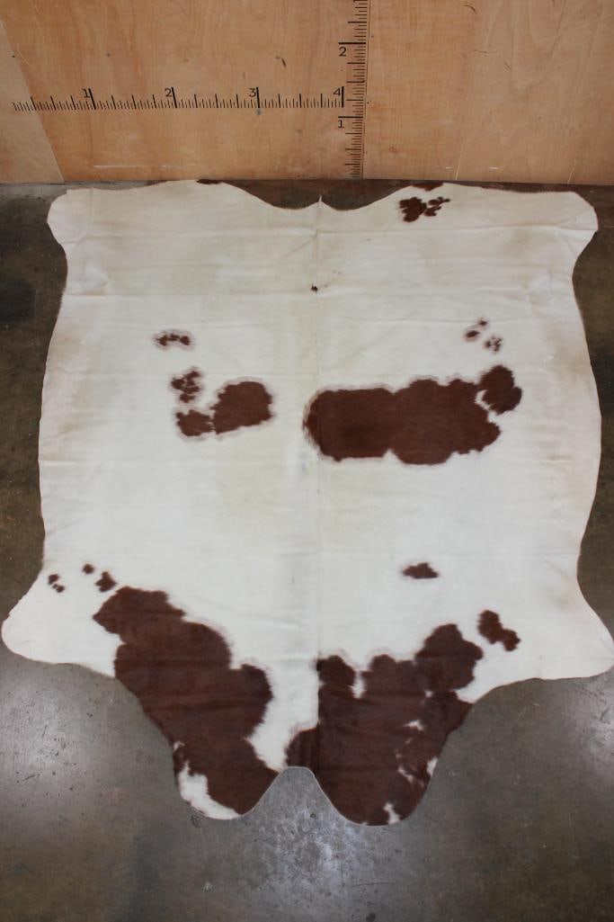 *Brand New* Brown and White COWHIDE or COWHIDE RUG: *Brand New* Brown and White COWHIDE or COWHIDE RUG. It measures 93" Long x 86" Wide and is made from 100% genuine Cowhide Leather. Cowhides are known for being durable, easy to clean, and