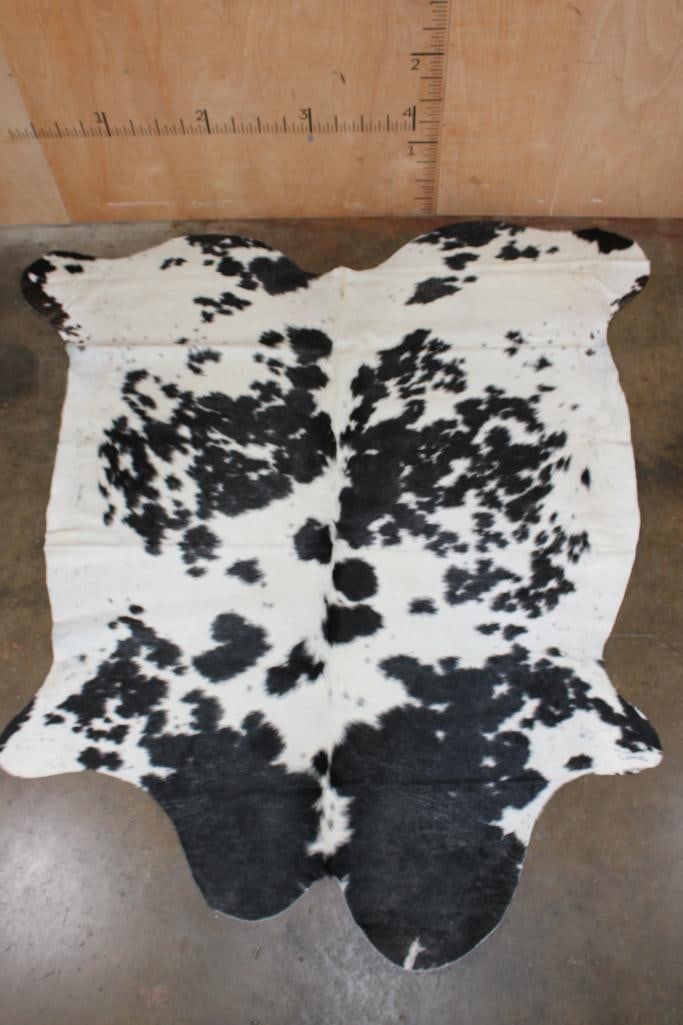 *Brand New* Black and White COWHIDE or COWHIDE RUG: *Brand New* Black and White COWHIDE or COWHIDE RUG. It measures 87" Long x 86" Wide and is made from 100% genuine Cowhide Leather. Cowhides are known for being durable, easy to clean, and