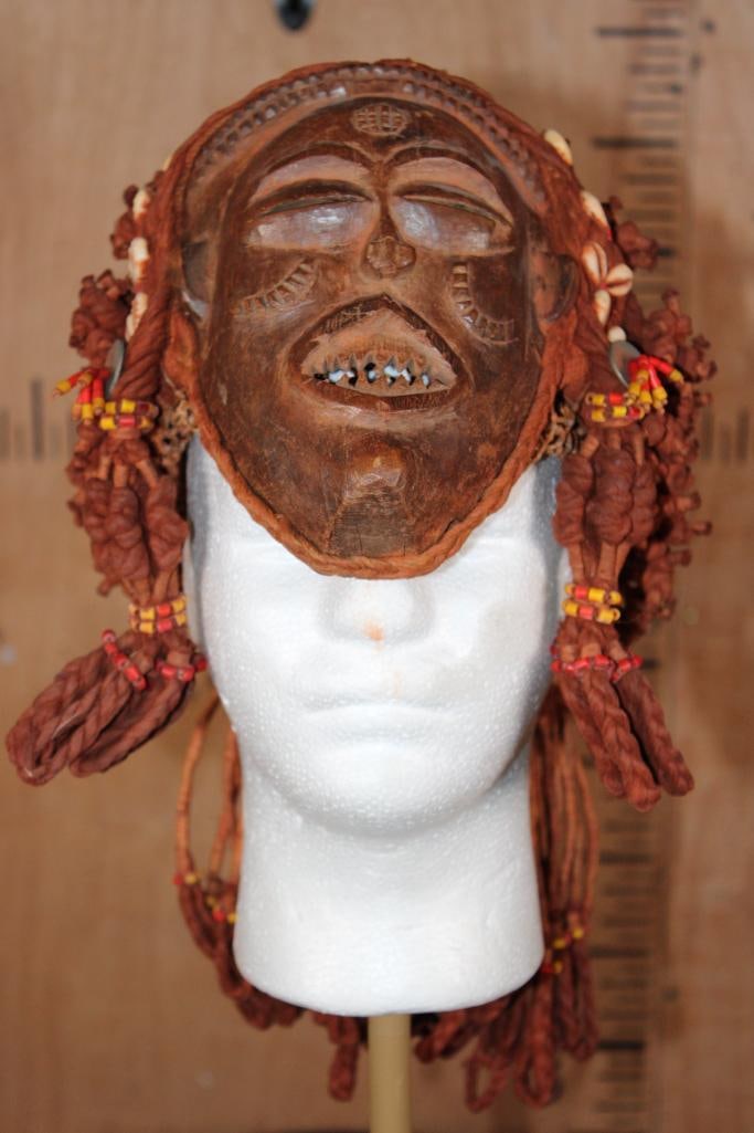 Chokwe MWANA PWO Mask from Central Africa with Cowrie Shells: Chokwe MWANA PWO Mask from Central Africa with Cowrie Shells. These traditional masks represent female ancestors and are carved from wood, decorated with cowrie shells, and adorned with elaborate