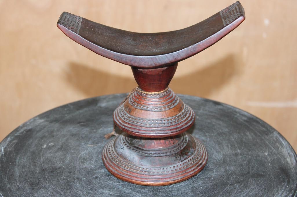 Traditional Ethiopian Headrest from the Oromo People, crafted from Wood: Traditional Ethiopian Headrest from the Oromo People, crafted from Wood. It measures 7" Long x 4 3/8" Wide x 6.5" Tall. Historically used as a pillow to support the head during sleep and protect elabo