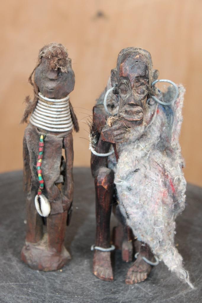 (2) Old Hand-carved Wood Figures from West or Central Africa: Old Hand-carved Wooden African Figures. There is a Man and Woman, likely from West or Central Africa. There is added materials like wire coils, beads, a cowrie shell, and fiber/textile elements. They