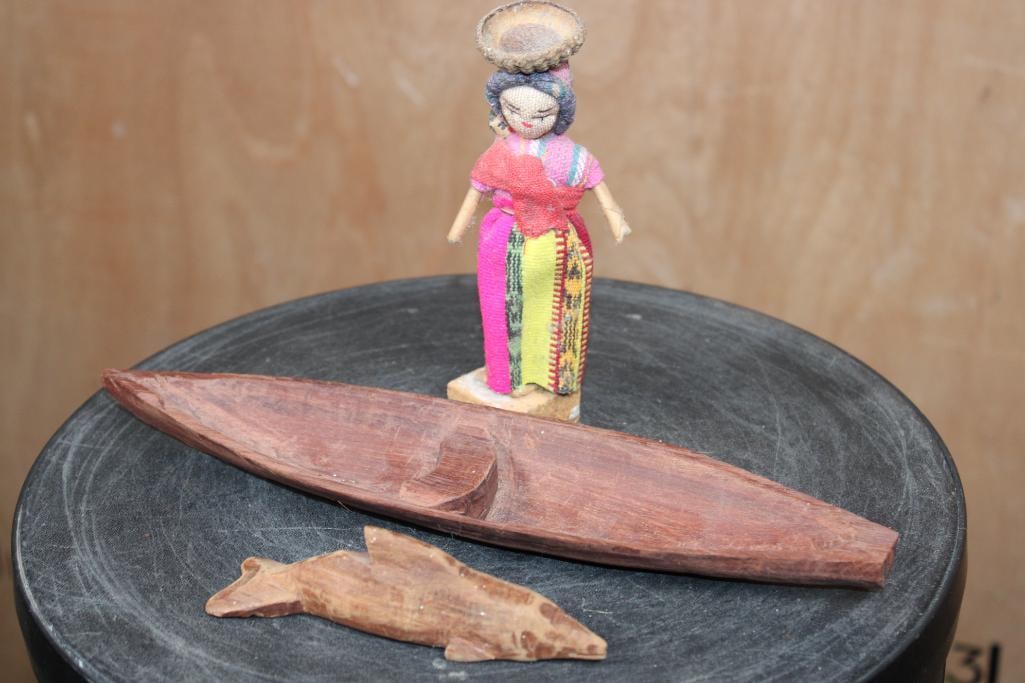 Peruvian Thread DOLL, Hand-carved DOLPHIN and Dugout CANOE: Hand-carved Peruvian Thread DOLL. She is in traditional clothing, holding her baby and has an acorn "basket" on her head. It measures 6" Tall x 2.5" Wide x 2" Depth. Hand-carved Wood DOLPHIN and