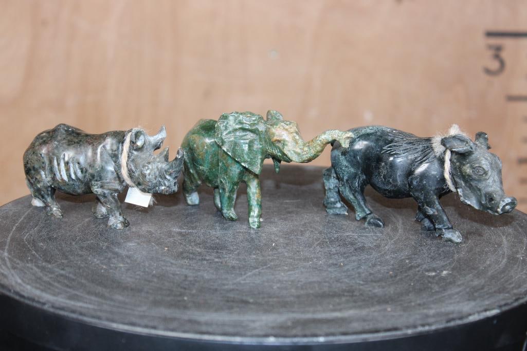 (3) Hand-carved Green Verdite Hardstone Animal Sculptures from Kenya: 3 Hand-carved Green Verdite Hardstone Animal Sculptures from Kenya. There is a Rhino that measures 4.25" Long x 1.25" Wide x 2" Tall. The Elephant measures 5" Long x 2" Wide x 2.5" Tall. The Warthog