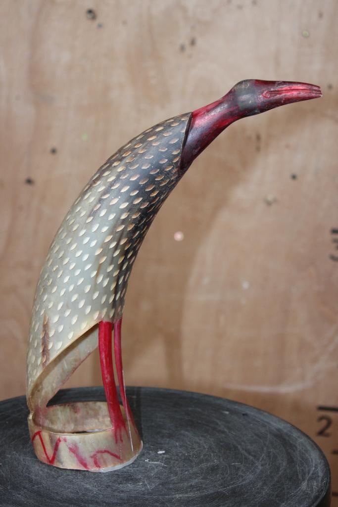 Hand-carved and Polished Steer Horn TOKAMPINI BIRD Totem from the Tiwi Islands: Hand-carved and Polished Steer Horn TOKAMPINI BIRD Totem from the Tiwi Islands. It measures 12" Tall. These carvings represent specific birds and are used in ceremonial contexts like the Pukamini