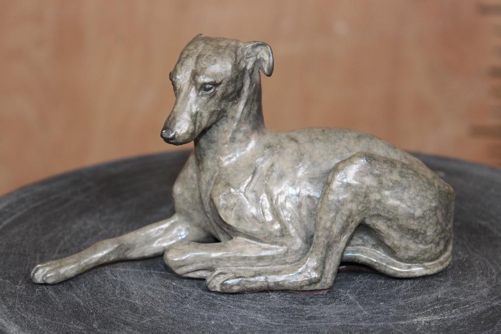 Bronze GREYHOUND Sculpture signed Tucker Bailey and Numbered 11/25: Bronze lying WHIPPET or GREYHOUND Sculpture designed signed "Tucker Baily 96" and Numbered 11/25. It measures 7" Long x 2.5" Wide x 3.25" Tall and Weighs 2.2 lbs. COLLECTIBLE BRONZE SCULPTURES 