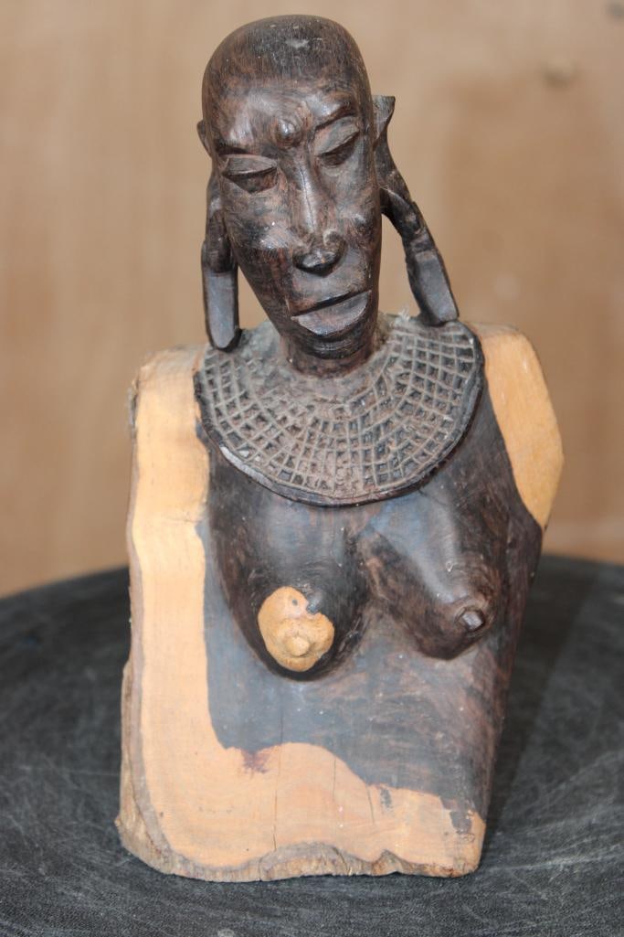 Hand-carved Maasai Woman Bust SCULPTURE: Vintage Hand-carved Maasai Woman Bust SCULPTURE. It measures 4.5" Long x 4" Wide x 8" Tall and Weighs 1 lb 12 oz. The figure features different tones on the bust and face and traditional adornments,