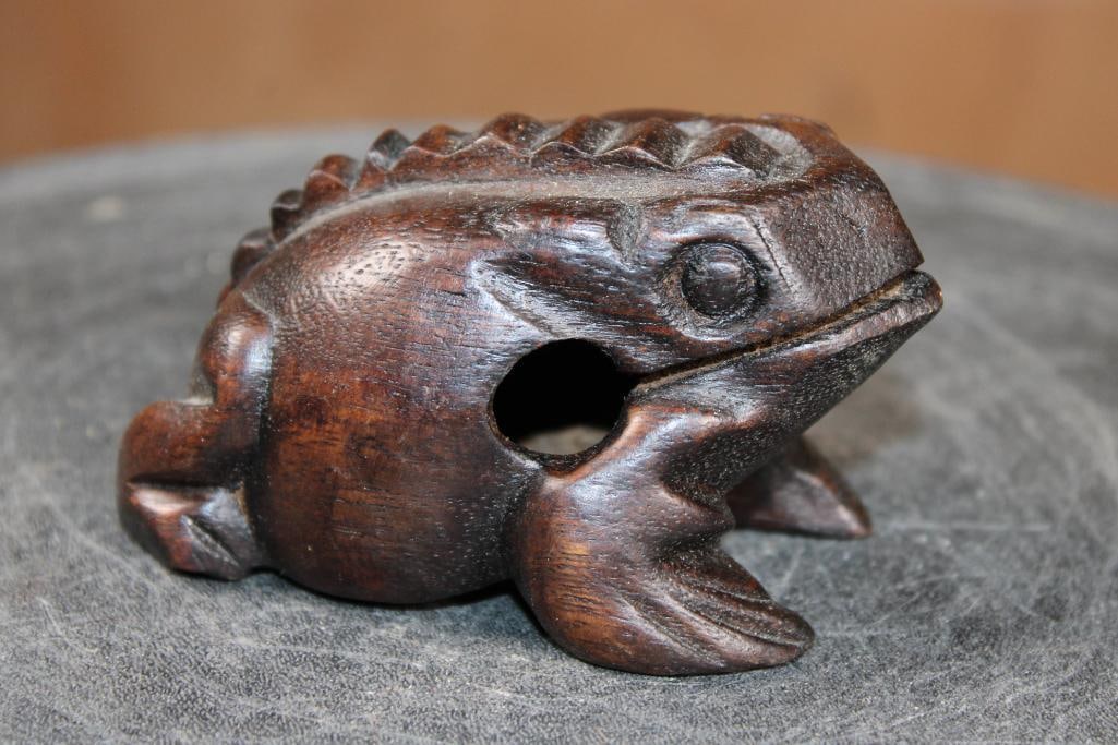Hand-carved Wooden Frog GUIRO or Percussion Instrument: Hand-carved Wooden Frog GUIRO or Percussion Instrument. It creates a "ribbit" sound when a stick or striker (included) is glided along the ridges on its back. They can be played as a tone block by