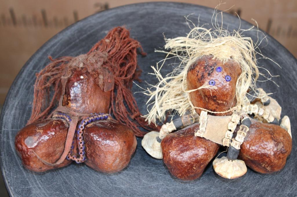 (2) Turkana Fertility DOLLS from Kenya with Salmon Vertebrae and Shells: 2 Turkana Fertility DOLLS from Kenya. These are made from the Doum Fruit and are embellished with Salmon Vertebrae and Shells. They measure approximately 4.25" Tall x 4.25" Wide x 2.5" Depth each.