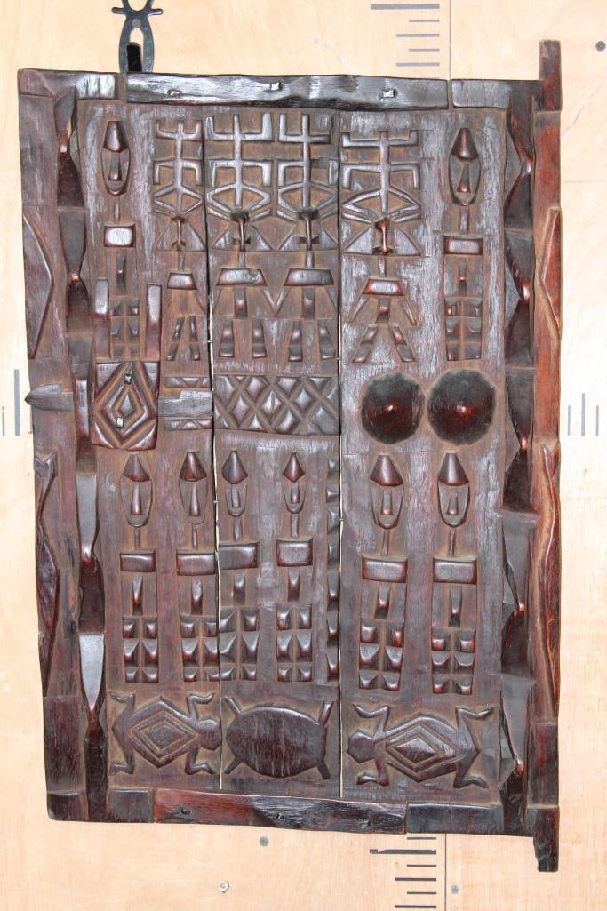 Ornate Hand-carved West African Indigenous Wood Dogon Granary DOOR from Mali: Ornate Hand-carved West African Indigenous Wood Dogon Granary DOOR from Mali. It measures 29" Tall x 18.5" Wide. It appears to be antique. There is a Wall Hanger and it has a sliding lock. COLLECTIBLE