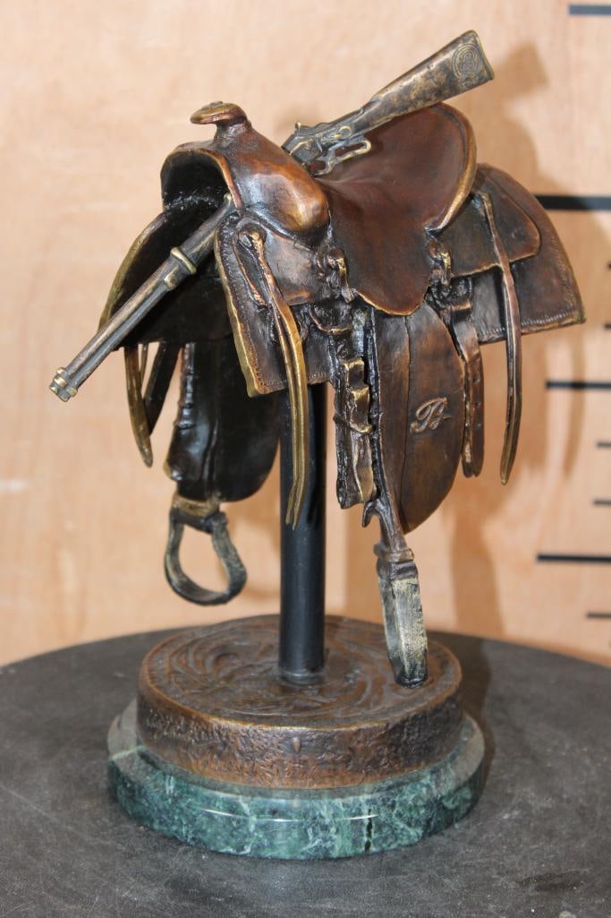 Original Limited Edition #185/2500 BRONZE Saddle Sculpture by Robert J. Beeler: Original Limited Edition #185/2500 BRONZE Saddle Sculpture signed by artist Robert J. Beeler. It measures 9.5" Tall x 6.25" Long x 5" Wide and Weighs 9 lbs 8 oz. It has a removable Winchester Rifle.