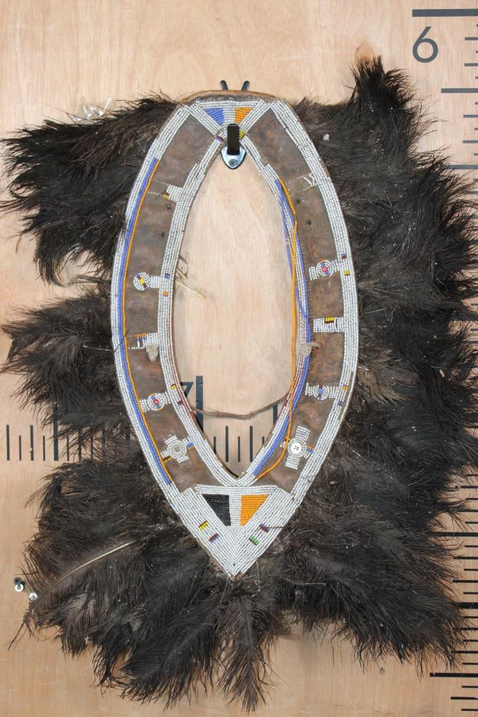 Enkuraru HEADDRESS from Kenya with Ostrich Feathers and Intricate Beadwork: Enkuraru HEADDRESS from Kenya with Ostrich Feathers and Intricate Beadwork. A Maasai warrior wears an ostrich feather headdress when going into battle. These are quite rare now that the killing of