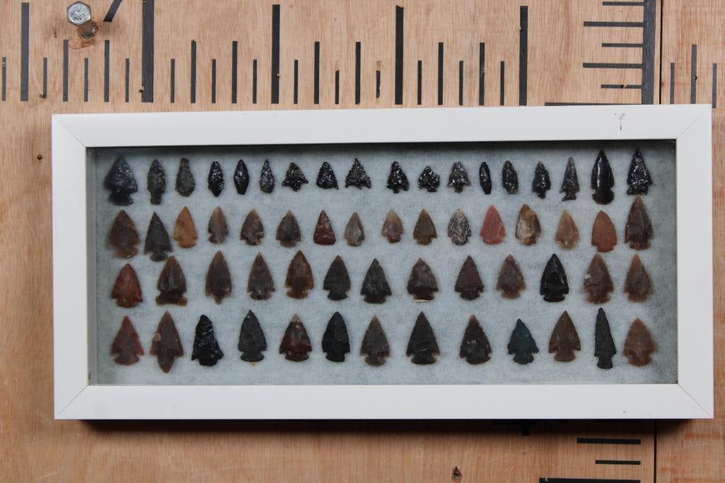 (60) Native American PROJECTILE POINTS or ARROWHEADS in a Glass Display Case: 60 Native American PROJECTILE POINTS or ARROWHEADS in a Glass Display Case. The Collection includes various styles, such as corner-notched points, which often date back to the Early Archaic period. Th
