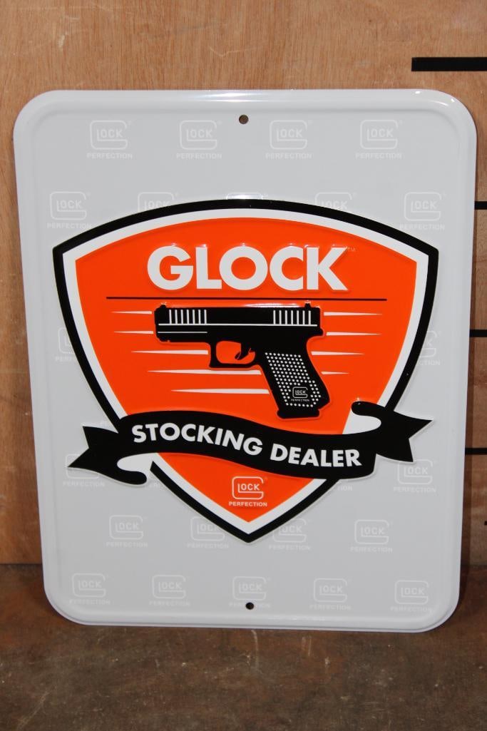Metal Glock "Stocking Dealer" Sign: Metal Glock "Stocking Dealer" Sign. It measures 12" Tall x 19" Wide. GUN ADVERTISING AND SIGNS 