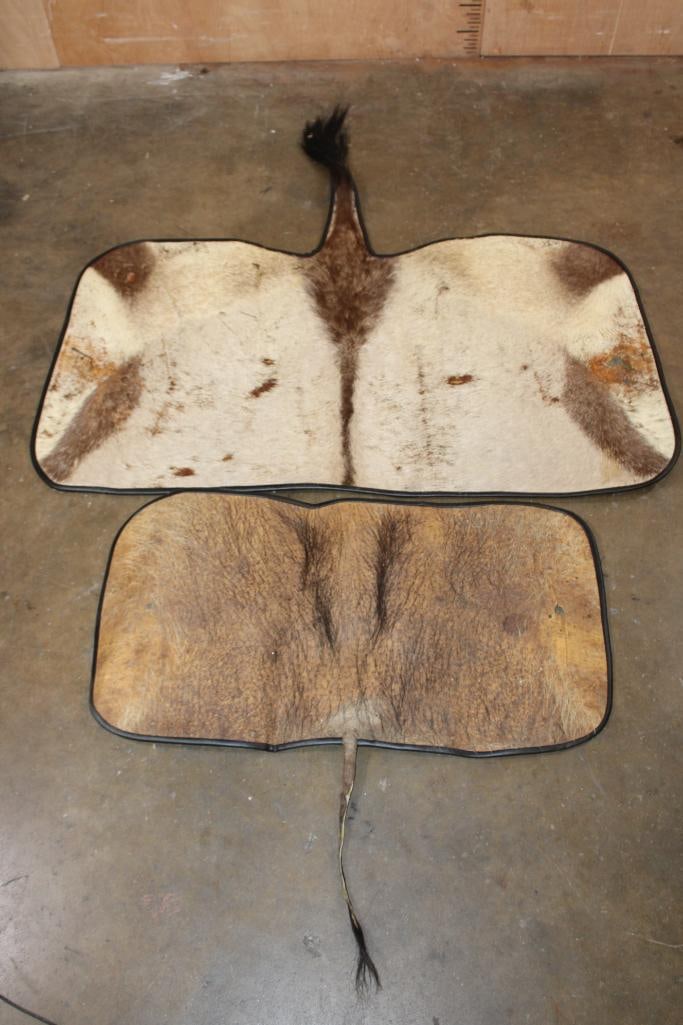(1) GEMSBOK Back Hide Rug and (1) WARTHOG Back Hide Rug: 1 GEMSBOK Back Hide Rug that measures 52" Long x 47" Wide and 1 WARTHOG Back Hide Rug that measures 37" Long x 33" Wide. They both have Carpet Backing and Leather Piping with wear from use. TAXID