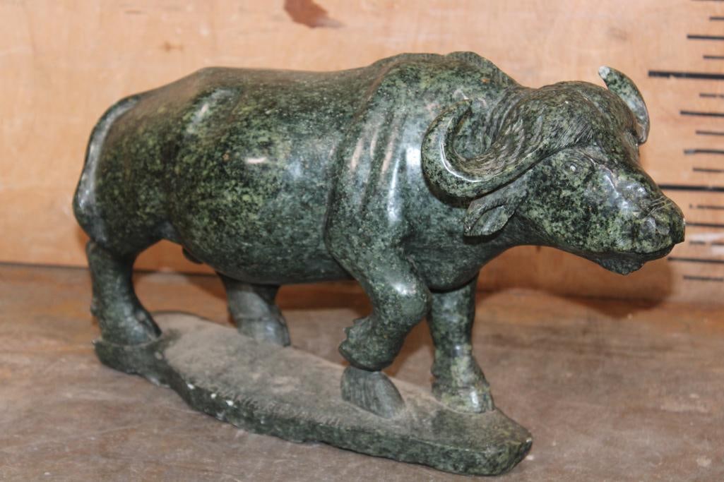 Hand-carved Cape Buffalo Soap Stone Sculpture: Hand-carved Cape Buffalo Soap Stone Sculpture. It measures 14.5" Long x 5" Wide x 9" Tall and Weighs 19 lbs 8 oz. The left horn has a repair. COLLECTIBLE STONE SCULPTURES 