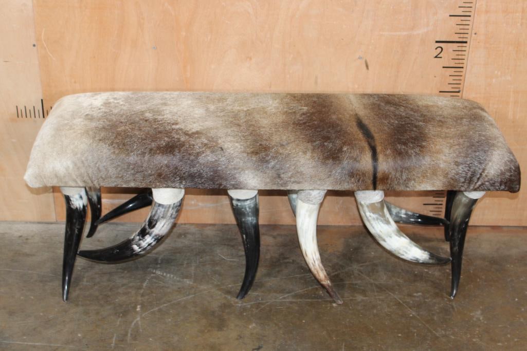 Rustic Upholstered COWHIDE Bench Seat with Polished Cow Horn Legs: Rustic Upholstered COWHIDE Bench Seat with Polished Cow Horn Legs. It measures 49" Long x 17" Wide x 19" Tall. TAXIDERMY FURNITURE