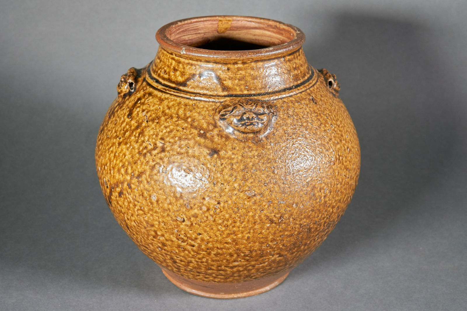 Small Chinese Martaban jar with 4 applied faces. (1 of 3)