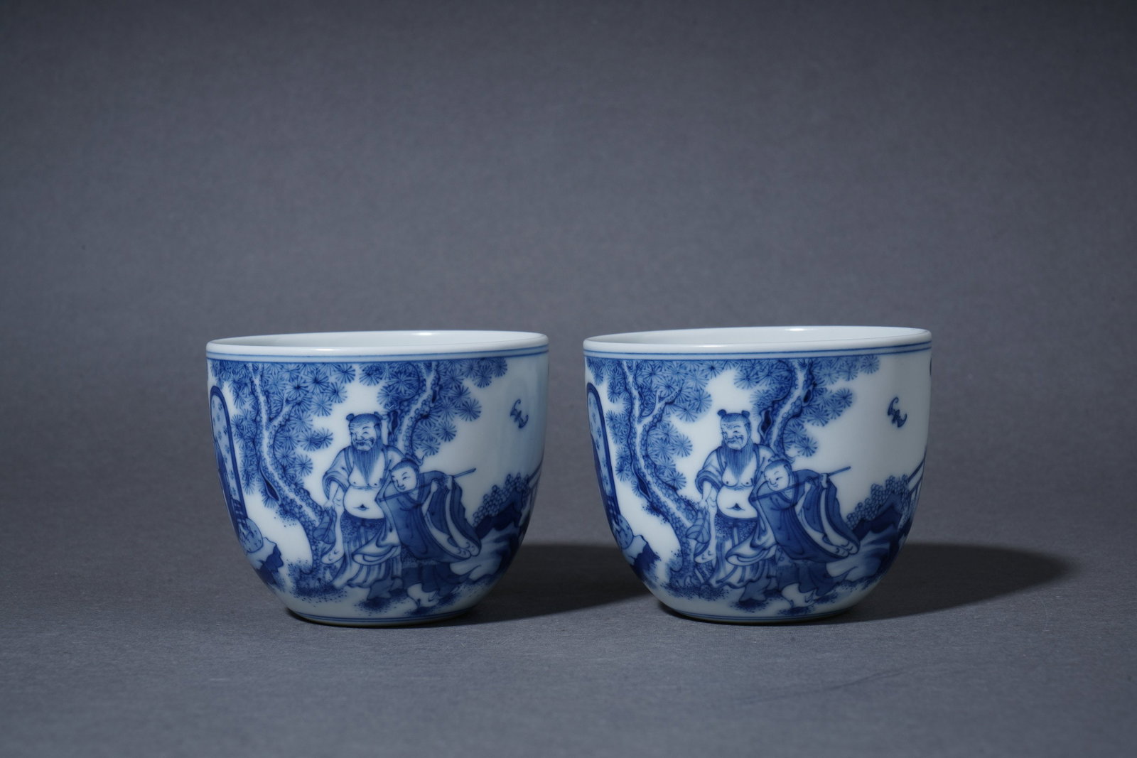 A Blue and white cup with figures: Height 5.5cm Width 6.8cm
