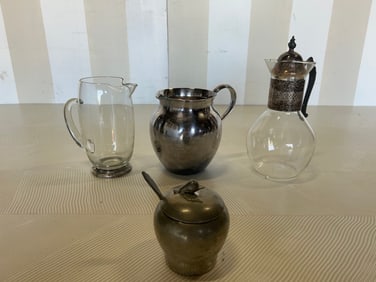 Grouping of pitchers- one with silver