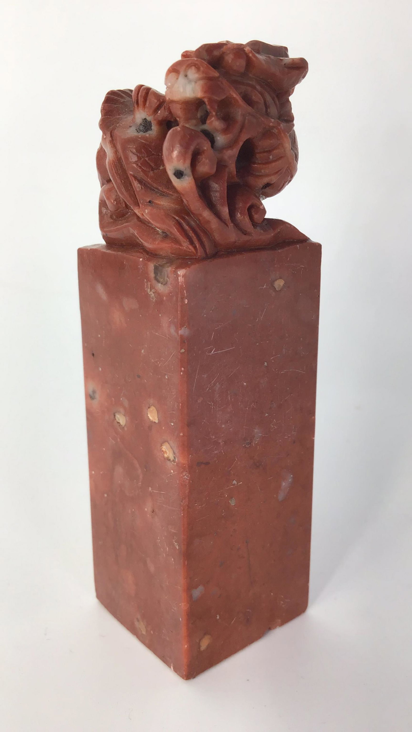 Carved Marble Seal: A finely polished seal-shaped soapstone with reddish suffusion, topped with a carved animal top. 3.25 tall.