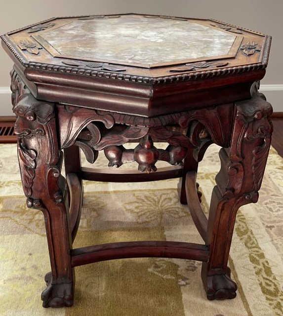 Marble Top Carved Asian Side Table: Heavily carved with flowers, berries and leaves. Inlaid marble top in patterned red/brown. 18.25 X 18.75 tall.