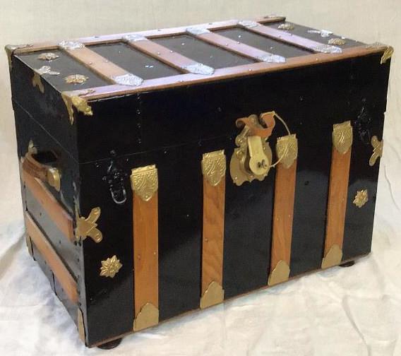 Restored Antique Trunk: Steamer trunk has been beautifully restored with wood banding, original leather side handles, fresh black paint, matching key and restored liner. Includes original organizer tray. Built in metal remov