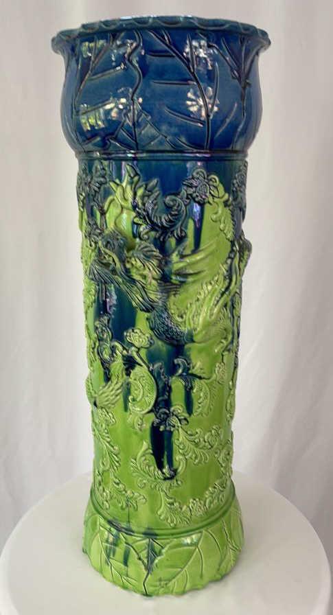 Antique Majolica Umbrella Stand: 9 X 24. Some chips and cracks, commensurate with age. Overall good condition. Dragon and leaves motif. Blue glaze running over lime green. Hole in bottom of stand.