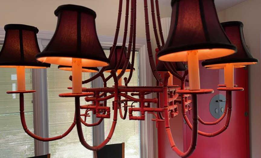 Vintage Pagoda Style Chandelier: Eight arm chandelier with metal base. Painted dark Chinese red. Small base bulbs, shades included. Working condition. Measures 32 inches diameter by 31 inches tall without chain, 50 inches tall with c