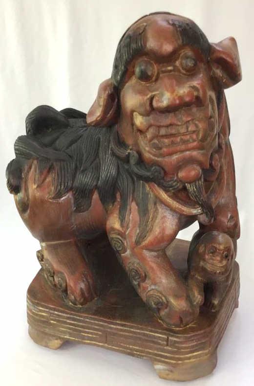 Female Chinese Foo Dog: Single lion dog or shishi, lacquer appearance, traditional red, gold and black colorings, paw over cub symbolizing protection of inhabitants of building.