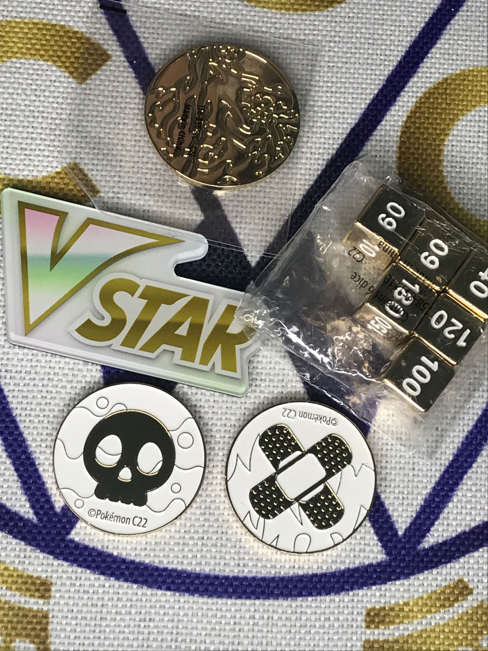 1 Charizard coin, 2 Pokemon game coins, dice, and vstar token: 1 Charizard coin, 2 Pokemon game coins, dice, and vstar token