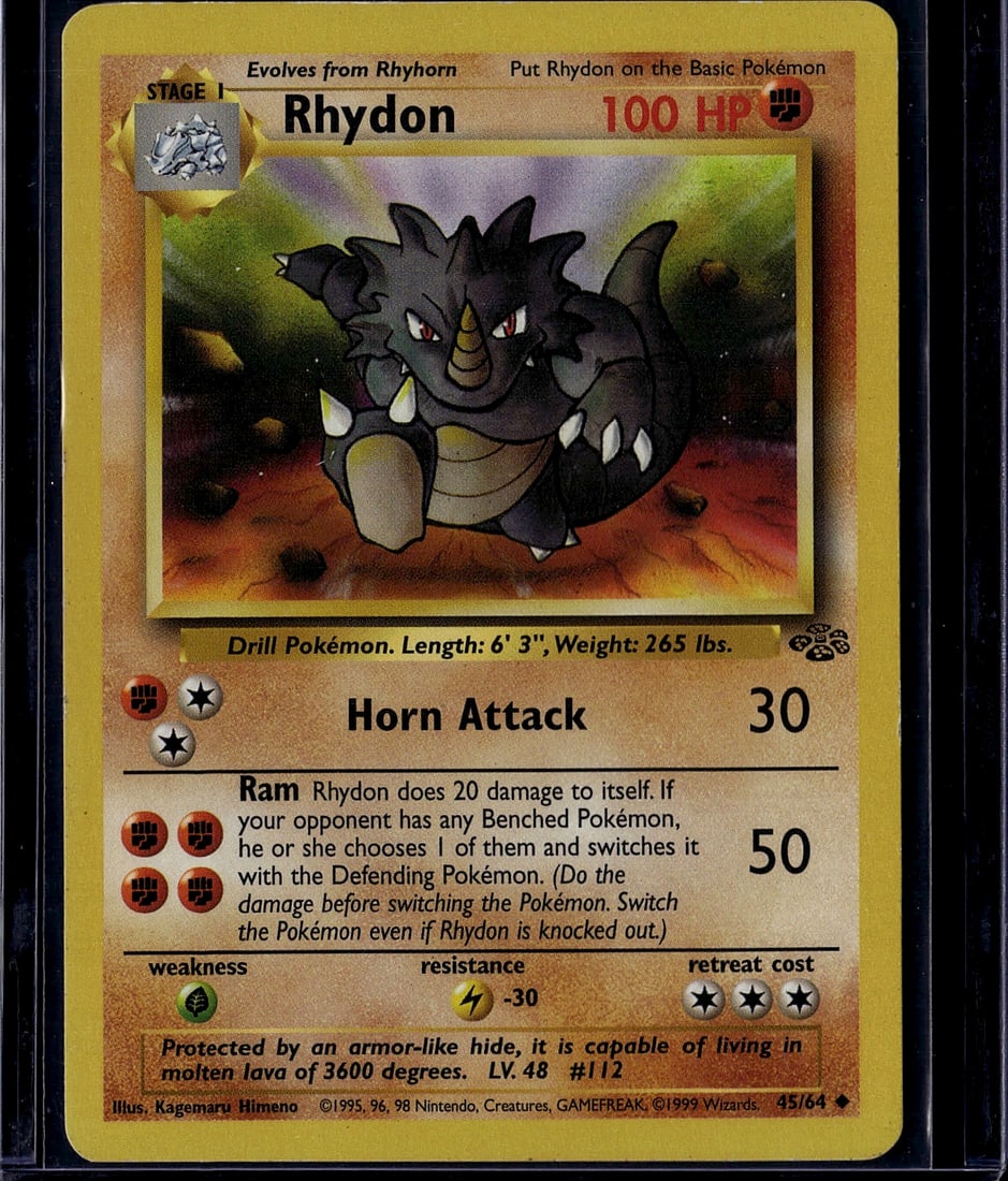 1999 Pokemon Base Set Rhydon #45/64 Wizards TCG C: This is an authentic 1999 Pokemon Trading Card Game Base Set Rhydon (#45/64) produced by Wizards of the Coast. This Stage 1 evolution card features the iconic Drill Pokemon with 100 HP and showcases t