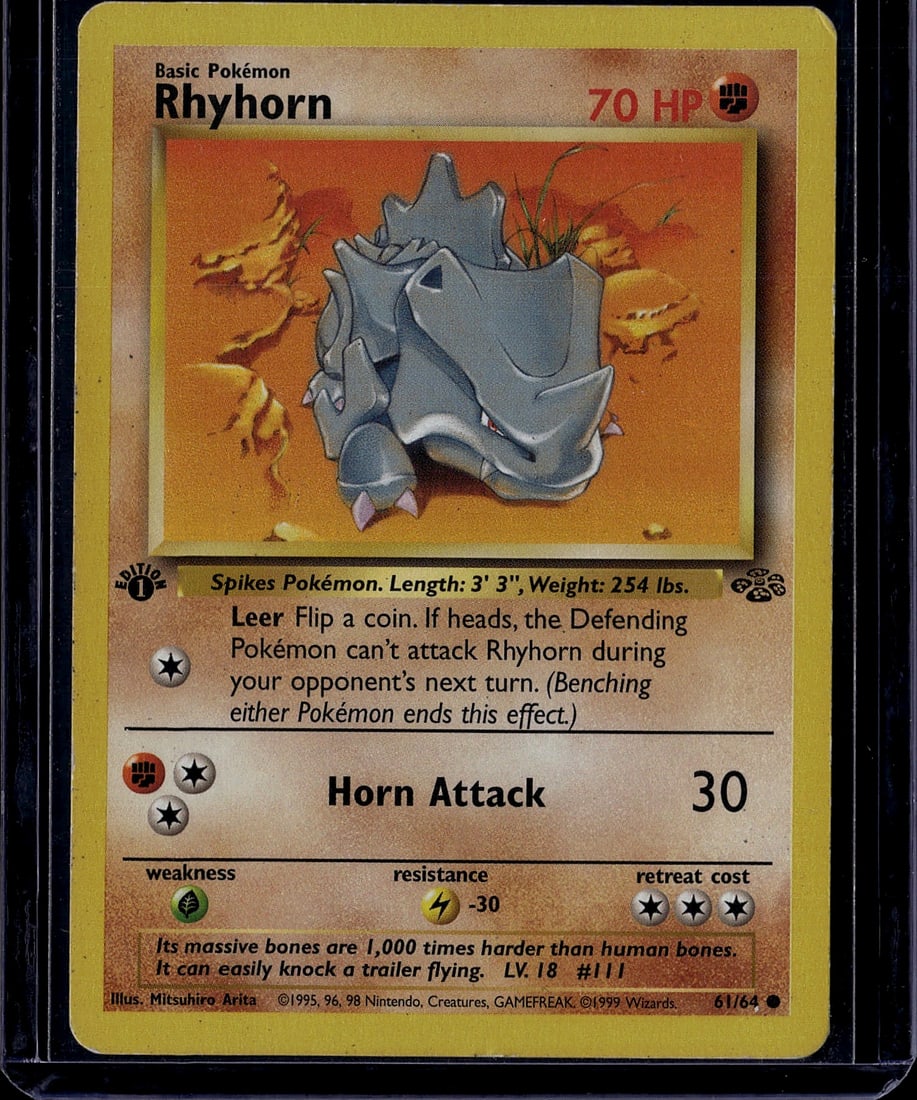 1999 Pokemon Base Set Rhyhorn 61/64 Raw Card - Cl: This is an authentic 1999 Pokemon Trading Card Game Base Set Rhyhorn card, numbered 61/64. The card features the iconic ground/rock-type Pokemon with its distinctive horn and spikes, set against a