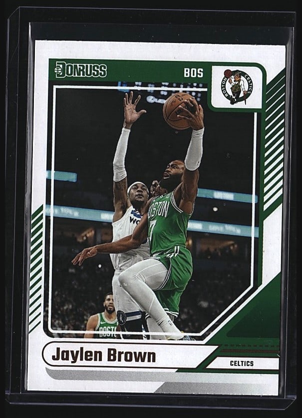 2024 Panini Donruss Jaylen Brown #25 Boston Celti: 2024 Panini Donruss #25 Jaylen Brown of the Boston Celtics. Raw single card in mint condition. Features Brown in action shooting over a defender in the classic Donruss design with green and white bord